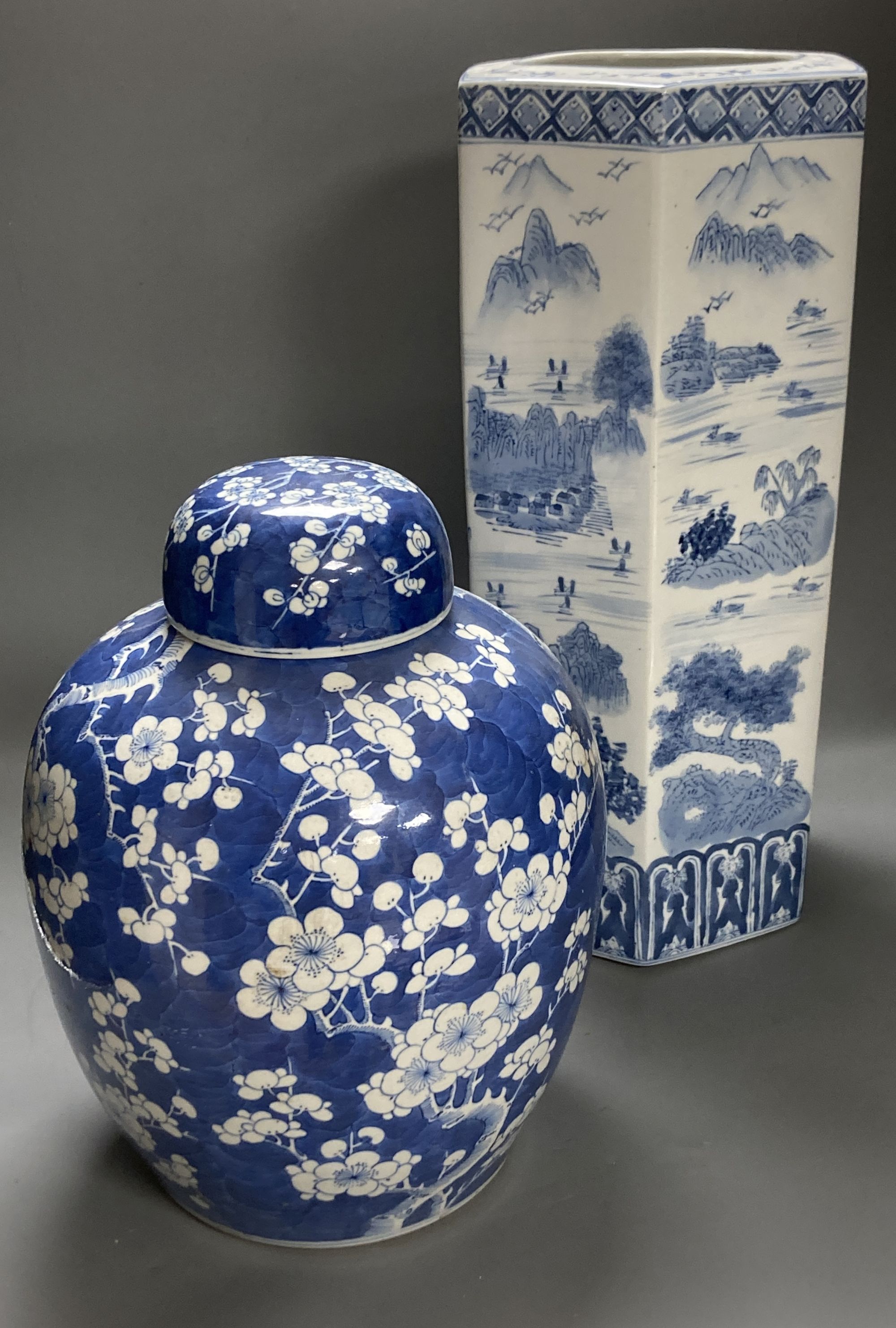 A large 19th century Chinese blue and white prunus jar and cover, height 35cm, and a late 20th century Chinese blue and white stick sta